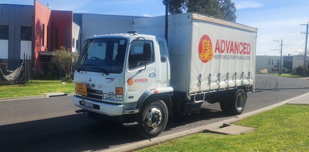 a light rigid truck parked on a street